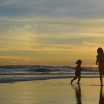 A family enjoying the beach at sunset