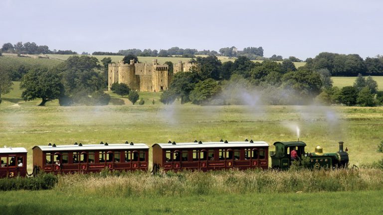 View of Kent and East Sussex Railway with Bodiam Castle in the distance, 1066 Country